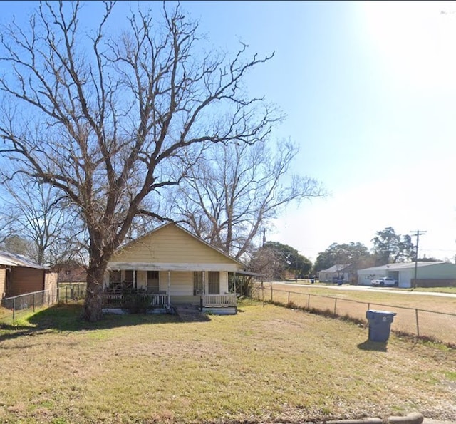 exterior space with a front yard and covered porch