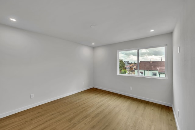 spare room featuring light hardwood / wood-style floors