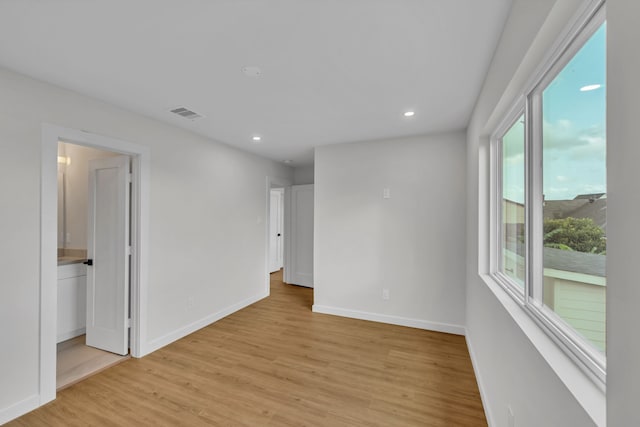 unfurnished room with light hardwood / wood-style floors