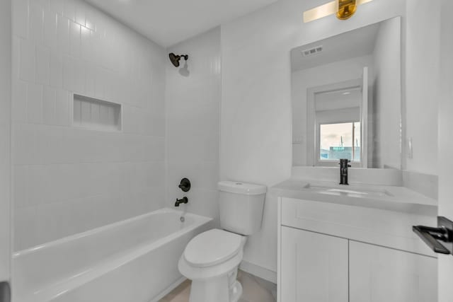 full bathroom with toilet, vanity, and tiled shower / bath combo