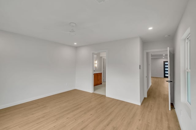 empty room featuring ceiling fan and light hardwood / wood-style flooring