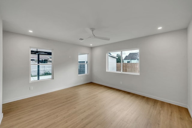 unfurnished room with ceiling fan and light hardwood / wood-style flooring