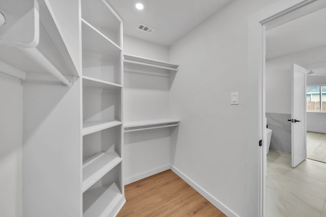 walk in closet featuring light hardwood / wood-style flooring