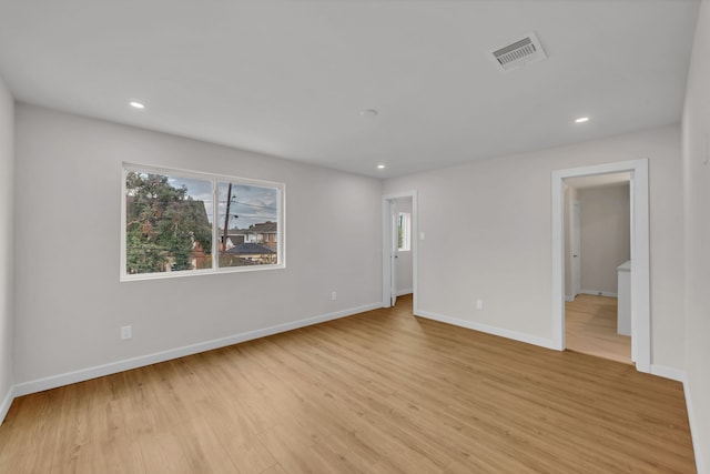 unfurnished room with light wood-type flooring