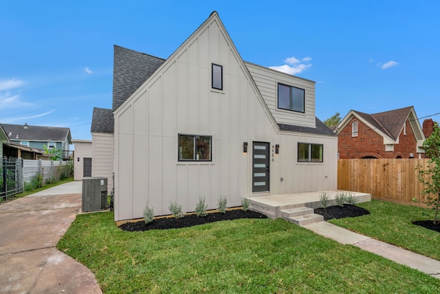 exterior space with a lawn and central air condition unit