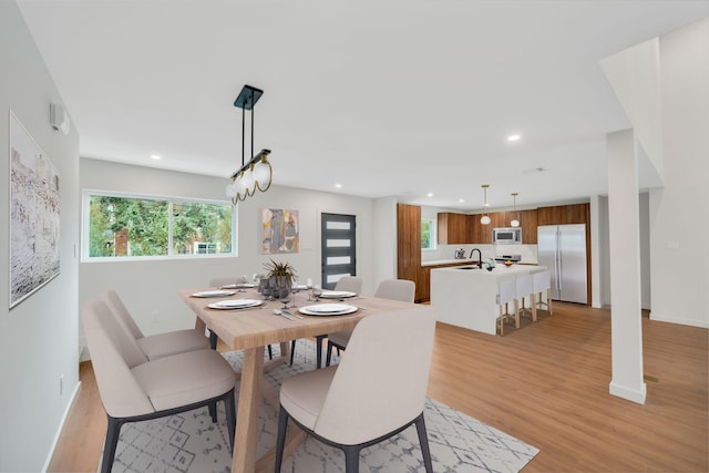 dining room featuring light hardwood / wood-style flooring and sink