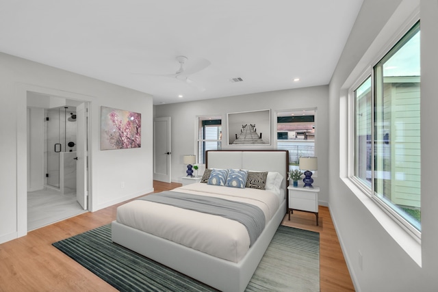 bedroom featuring hardwood / wood-style floors, ceiling fan, and ensuite bathroom