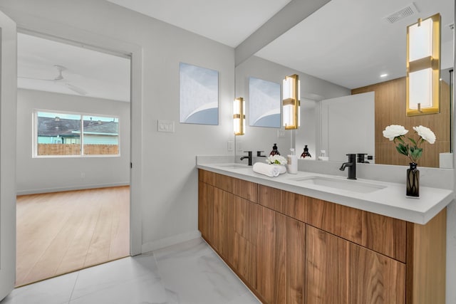 bathroom featuring ceiling fan, vanity, and wood-type flooring