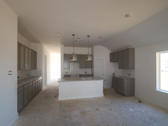 kitchen featuring a kitchen island, gray cabinetry, decorative backsplash, and decorative light fixtures