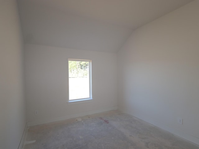 spare room with vaulted ceiling