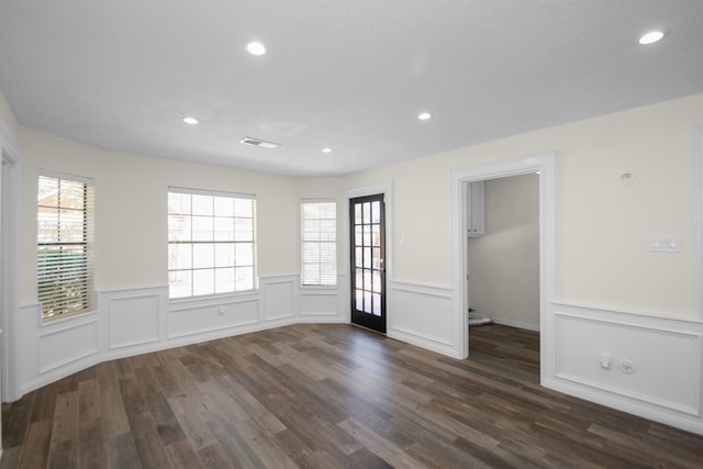 spare room with dark hardwood / wood-style floors