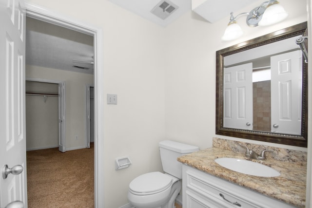 bathroom featuring toilet and vanity