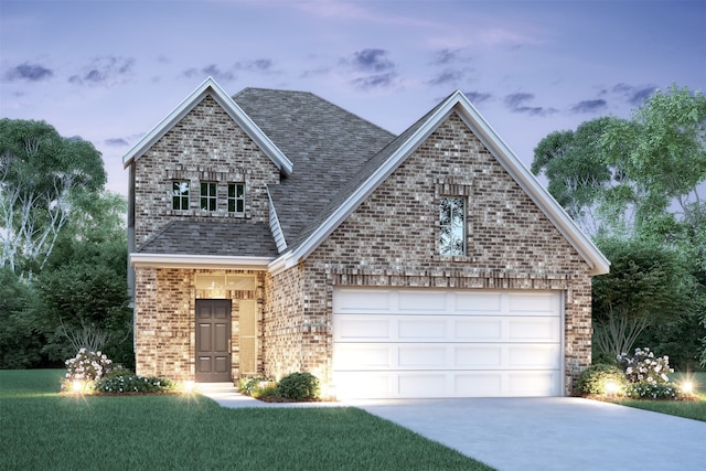 view of front of property featuring a garage and a yard