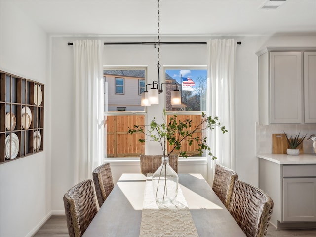 dining room with wood-type flooring