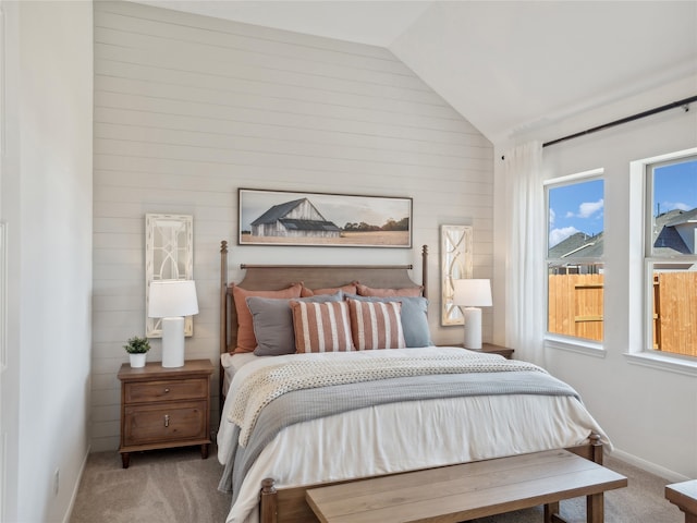 carpeted bedroom with vaulted ceiling