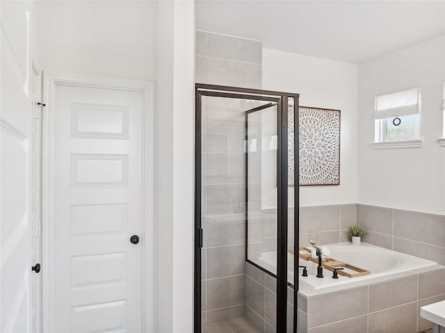 bathroom with separate shower and tub