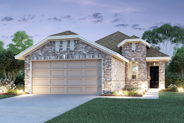 view of front of home featuring a garage and a lawn