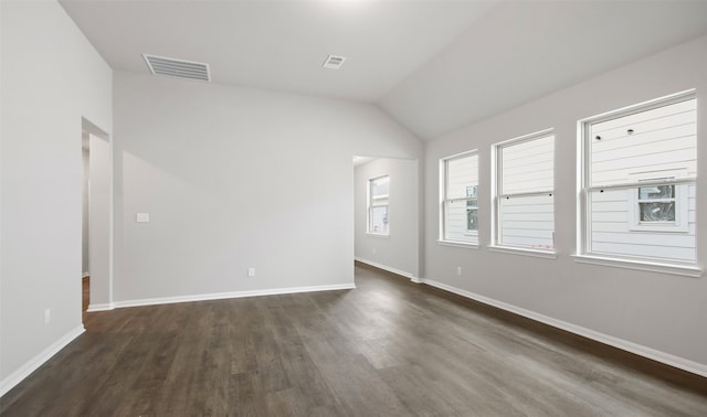 empty room featuring lofted ceiling and dark hardwood / wood-style floors