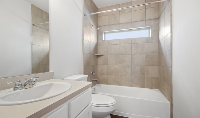 full bathroom with vanity, toilet, and tiled shower / bath