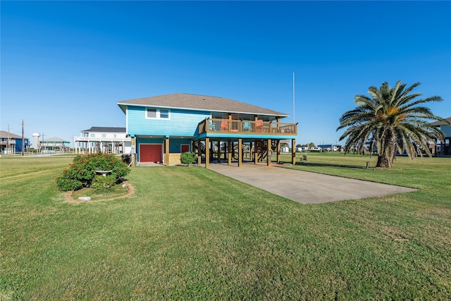 back of house featuring a carport, a garage, a deck, and a yard