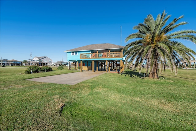 rear view of property featuring a yard and a carport