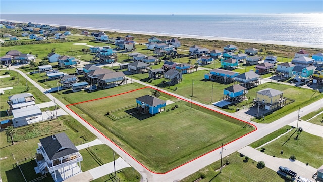 birds eye view of property with a beach view and a water view