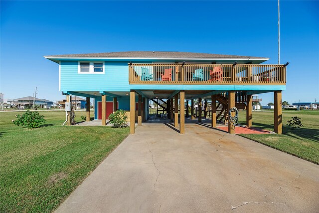 raised beach house with a carport, a deck, and a front yard