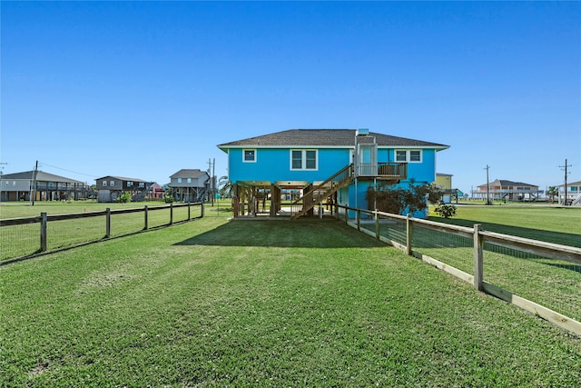 rear view of property featuring a yard