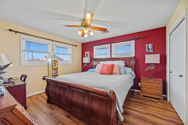 bedroom featuring hardwood / wood-style floors, ceiling fan, and a closet