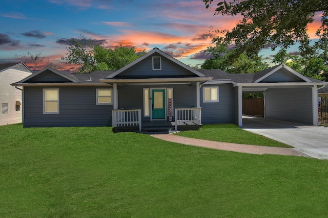 ranch-style house featuring a porch, a carport, a front lawn, and driveway