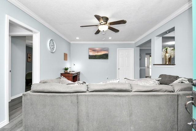 living room with a textured ceiling, ceiling fan, crown molding, and hardwood / wood-style flooring