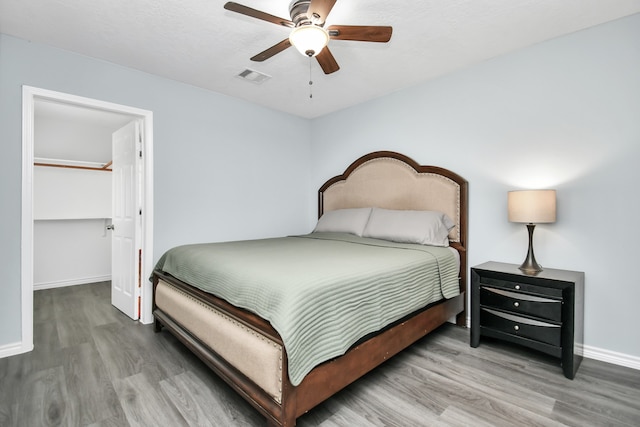 bedroom with ceiling fan and wood-type flooring