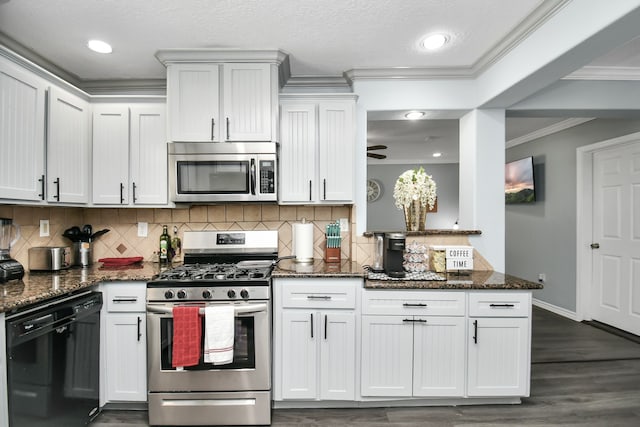 kitchen with decorative backsplash, white cabinets, appliances with stainless steel finishes, and dark stone countertops