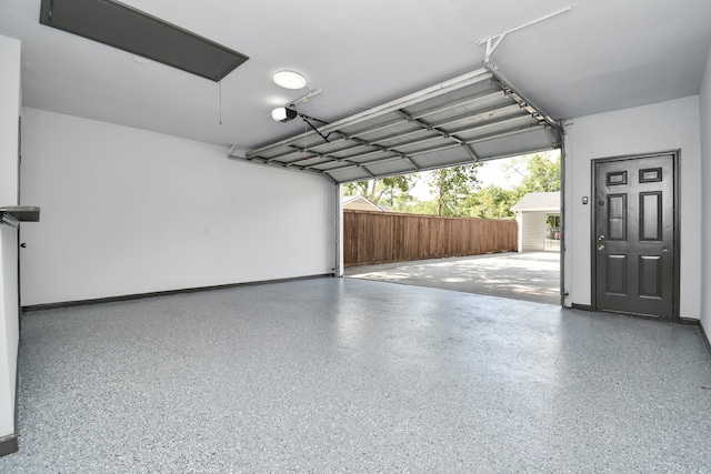 garage with a garage door opener and wood walls