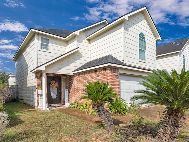 view of front of home with a front lawn and a garage