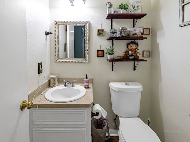 bathroom featuring toilet and vanity