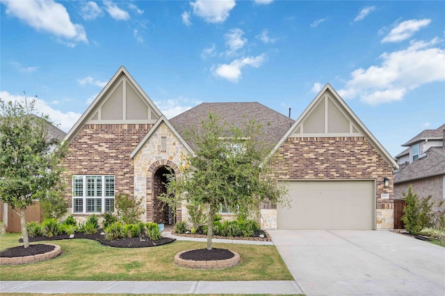 english style home with a garage and a front lawn