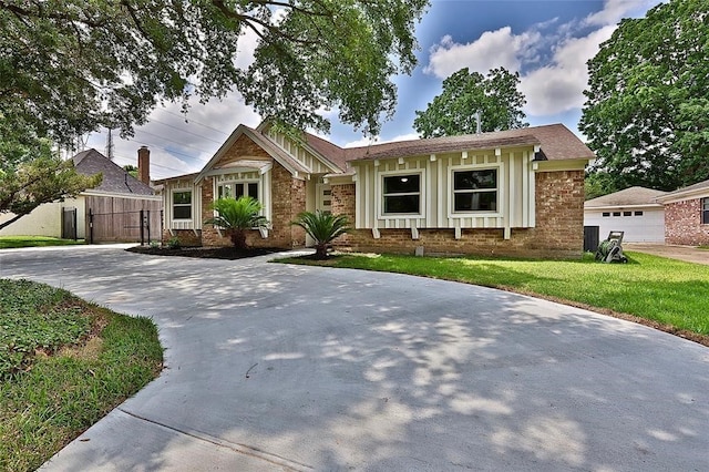 view of front of home with a garage and a front lawn