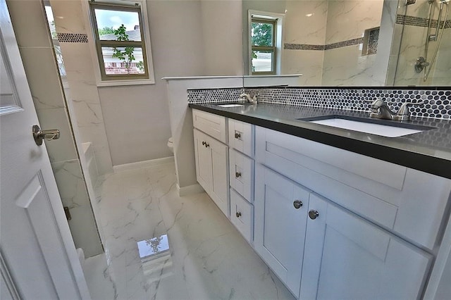 bathroom featuring tiled shower, vanity, toilet, and backsplash