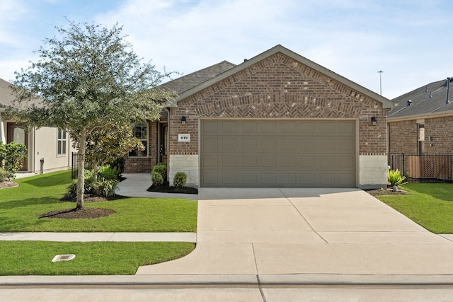 ranch-style house featuring a garage and a front lawn