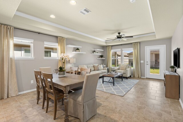 dining room featuring a tray ceiling and ceiling fan