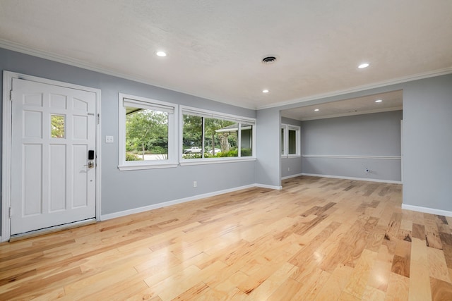 entrance foyer featuring crown molding and light wood-type flooring