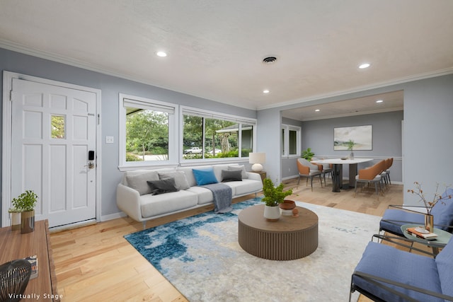 living room with wood-type flooring and ornamental molding