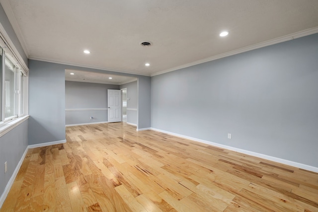 unfurnished room featuring ornamental molding and light hardwood / wood-style floors