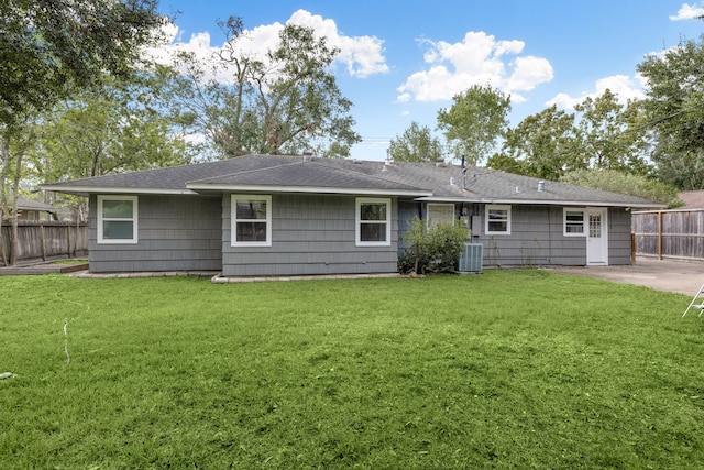 back of house with a yard, a patio area, and central air condition unit