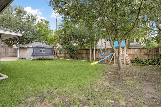 view of yard featuring a playground and a trampoline