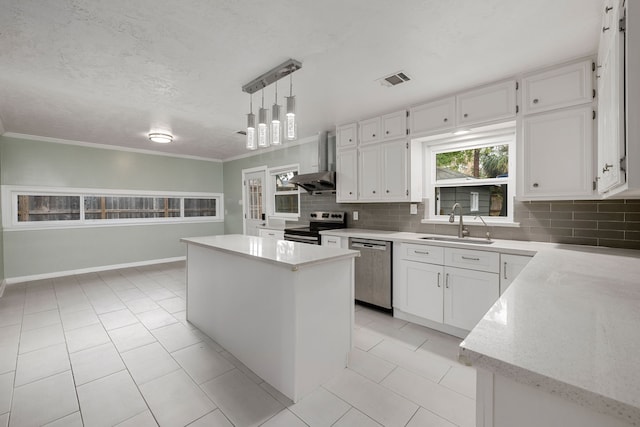 kitchen with wall chimney range hood, stainless steel appliances, white cabinets, and a kitchen island