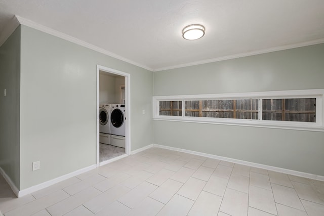 washroom with ornamental molding and washing machine and clothes dryer