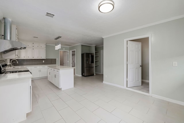 kitchen featuring crown molding, white cabinetry, hanging light fixtures, stainless steel refrigerator with ice dispenser, and a kitchen island