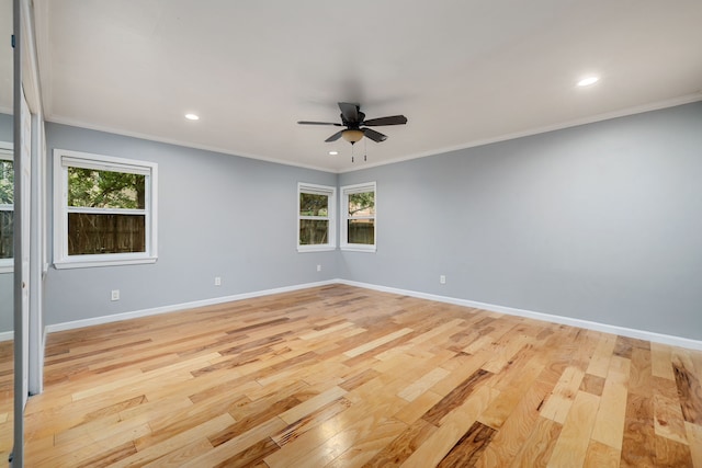 unfurnished room with crown molding, ceiling fan, light hardwood / wood-style flooring, and a wealth of natural light